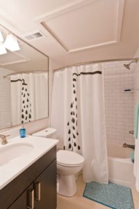 Old City apartment with subway tile bath and large vanity mirror