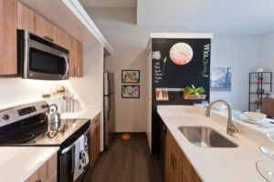 Old City apartment kitchen with stainless steel appliances, quartz countertops, and breakfast bar